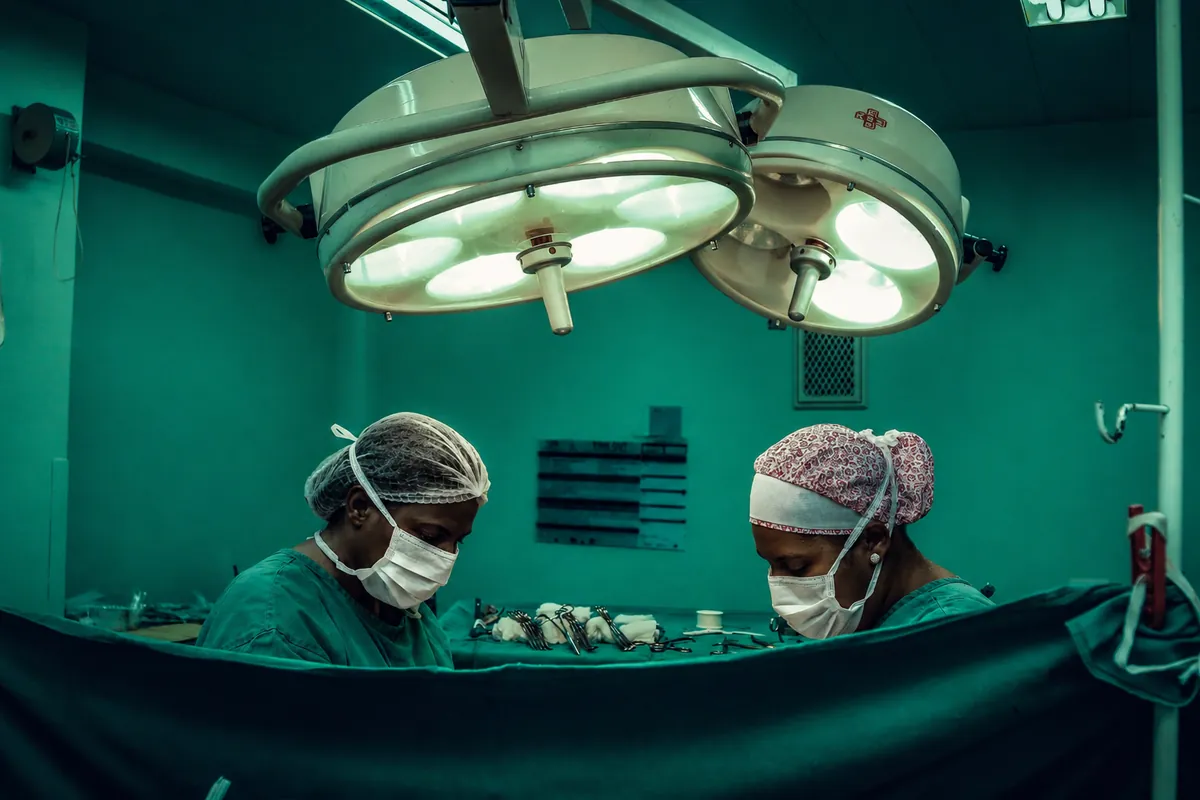 Medical team looking down in an operating theatre